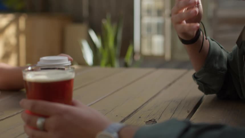 Two people sit down with drinks in the restaurant