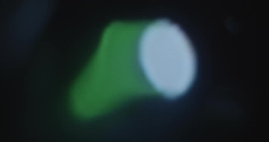 Extreme macro closeup of a phone or computer screen with a switch reminiscent of a standard apple device power button being turned on and off automatically by the OS or operating system