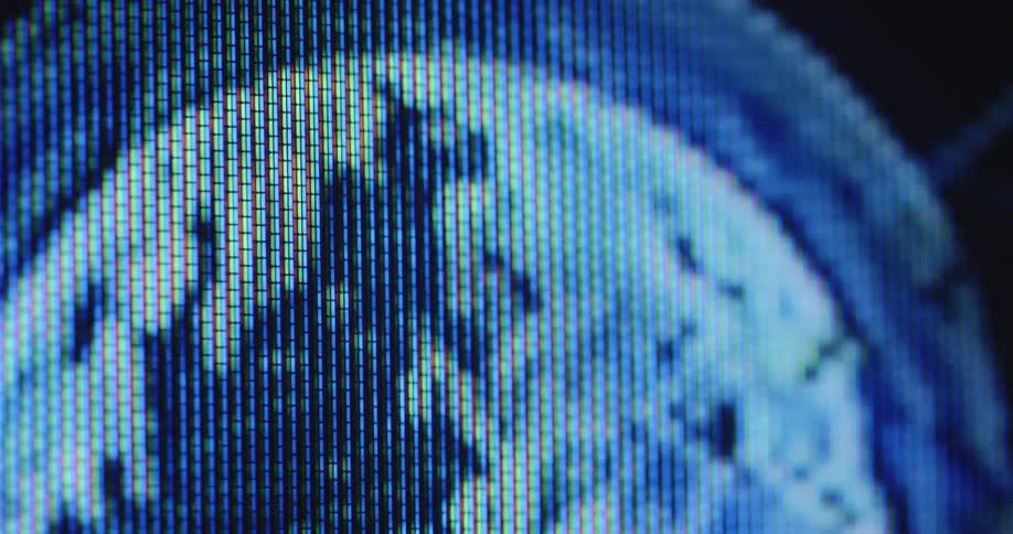 Extreme closeup of a television or TV screen displaying a rotating digital earth animation surrounded by the atmosphere and orbit with futuristic effects and camera movement