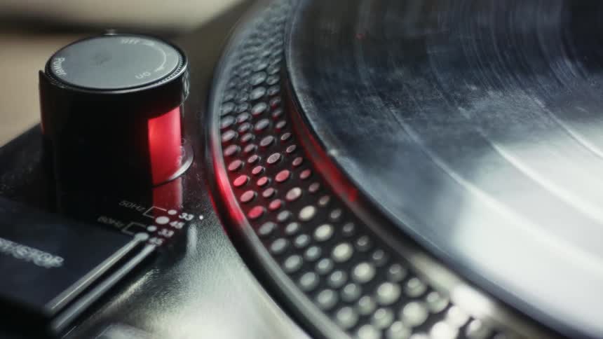 A person plays a record