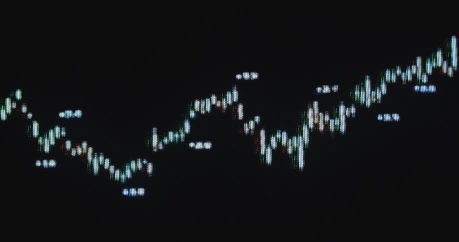 Multiple data points at different values are continuously plotted next to a candle chart of a stock or crypto currency trading graph in a finance application or app on a dark pixelated computer screen