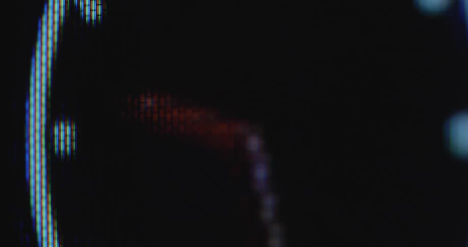 The hours minutes and seconds are passing quickly as the hands of an animated wall clock or watch spin quickly and in a fast way on a retro RGB pixel television screen captured with dynamic camera movement