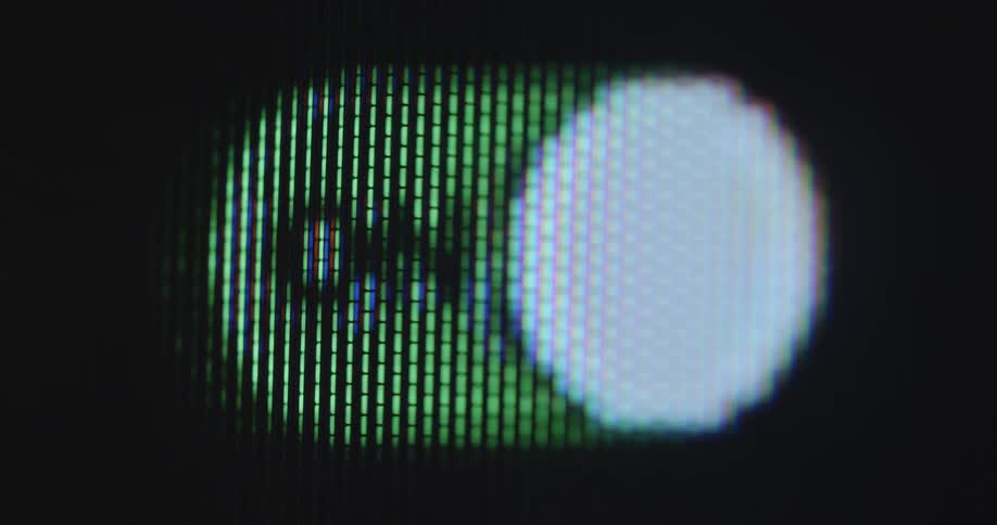 Male person uses index finger to turn user interface switch on touchscreen on and off switching between green and red setting with a dark black background and handheld camera movement
