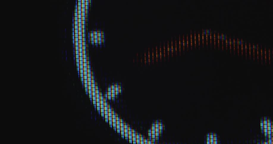 Extreme macro shot with dynamic and smooth camera movement of a clock or watch that spins quickly during a time lapse on the TV display with RGB pixels as time passes in a fast way