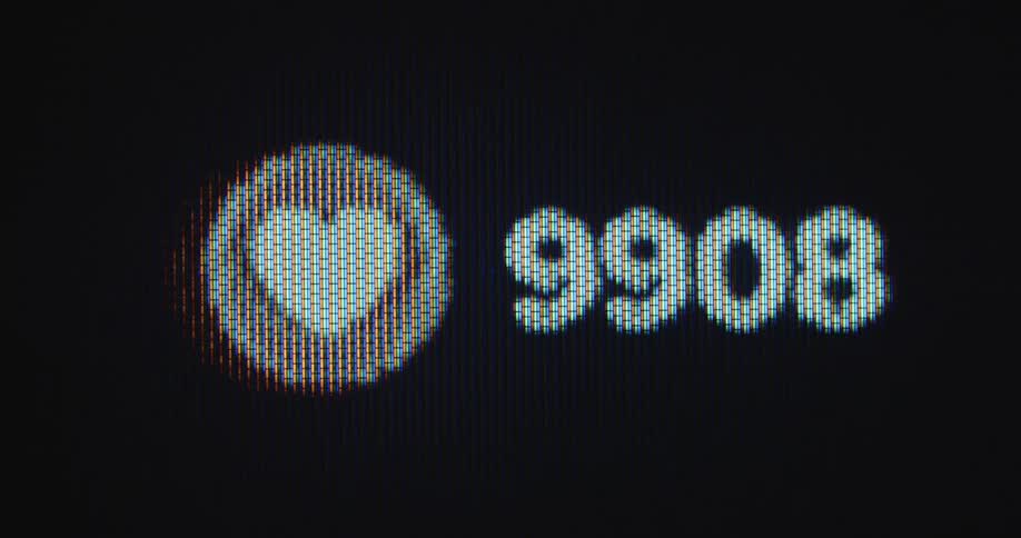 Extreme closeup of a digital screen with pulsating heart icon and numbers of likes reaching 10 thousand as symbol for success and growth on social media platforms due to great online marketing