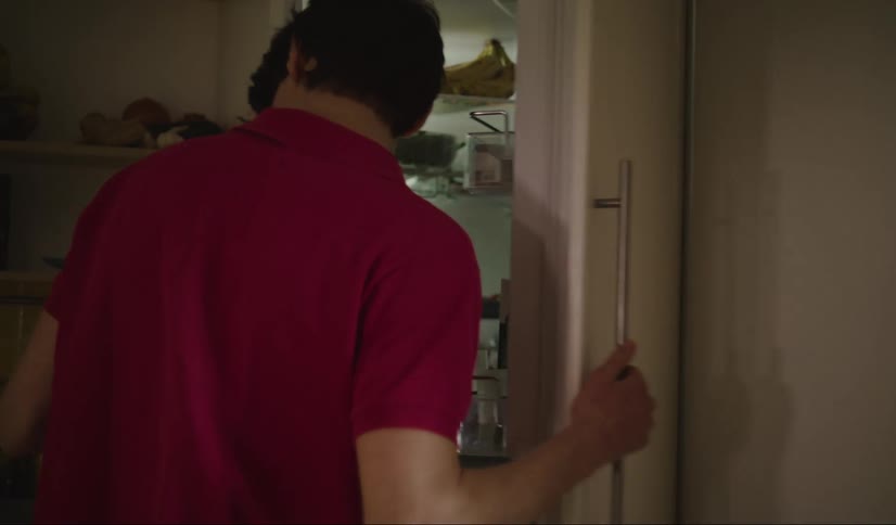 Man opens the fridge at home