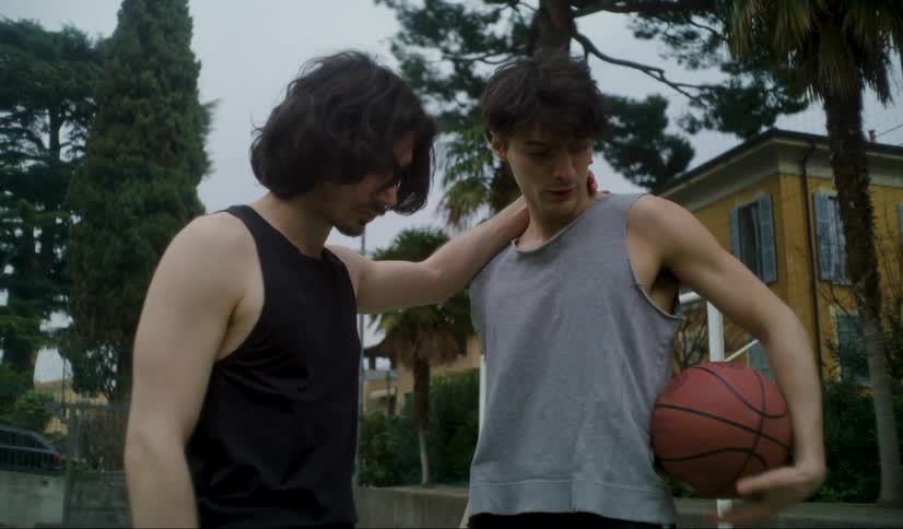 Two close friends talk while playing basketball