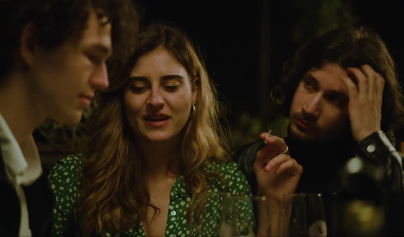 Three friends talk at night