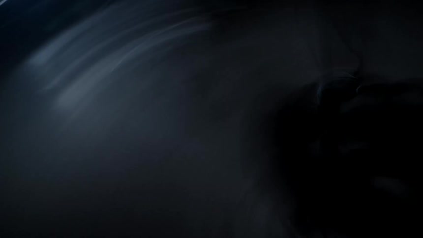 The camera spins chaotically around a bicycle in a dark garage