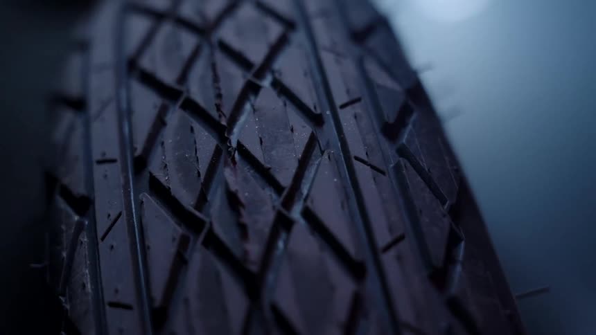 A close up of a motorcycle tire with a black and white tread pattern