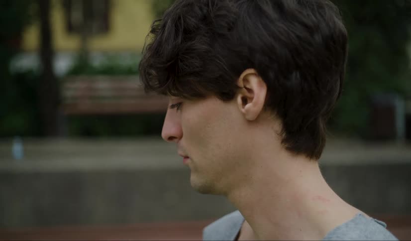 Close up of the face of a young man looking around