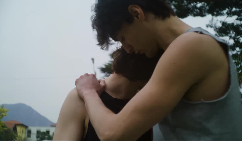Young man hugs and consoles a friend