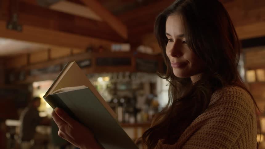 Woman finds a book on a cafe