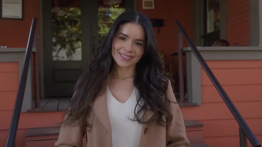 Young happy woman smiles at the camera
