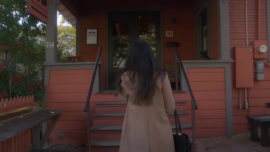 Woman walks to a coffee shop in the neighborhood
