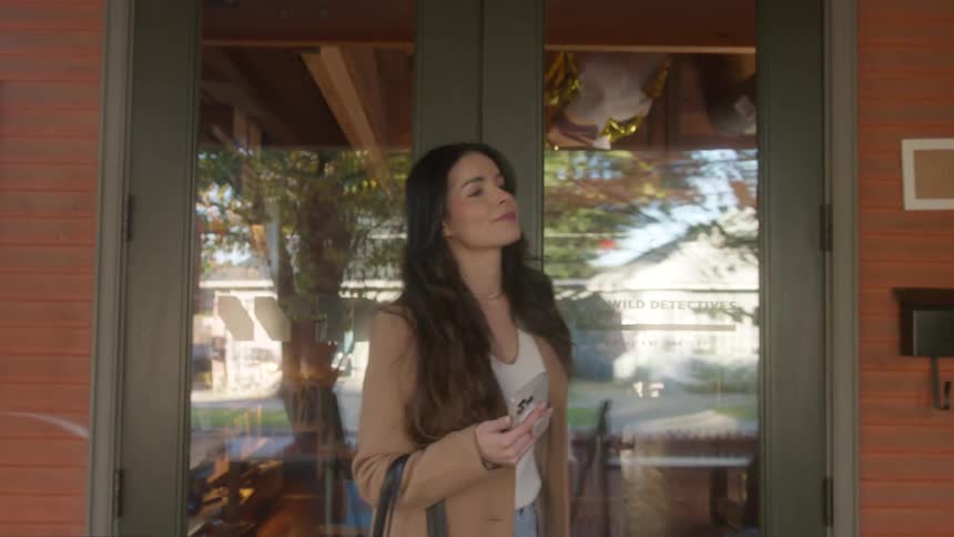 Satisfied woman walks out of a small shop