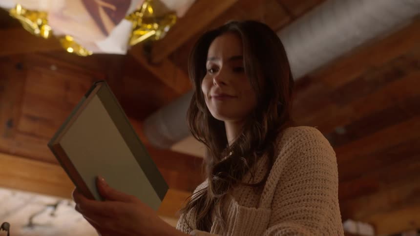Woman finds a book she likes on the bookstore