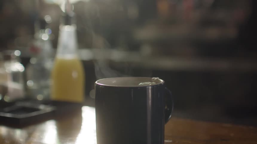 A mug with some hot liquid smoking at the top