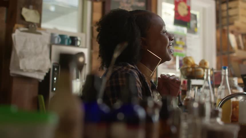 Bartender talks to customers in the bar