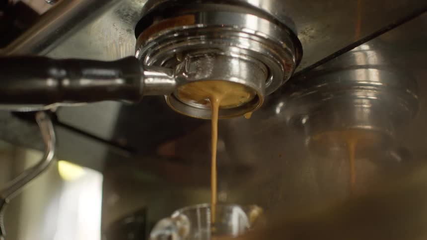 Close up of an espresso machine pouring coffee