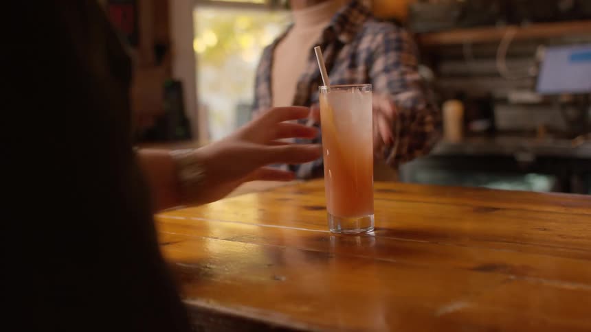 A customer is served his drink