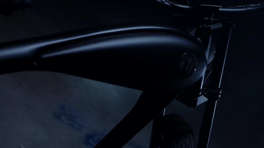 Black bicycle with fat tires stands on a concrete floor