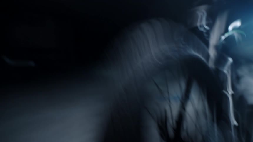 The motorcycle is parked in the dark garage