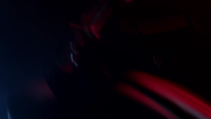 A dark environment with some lights moving slowly in a blurred manner