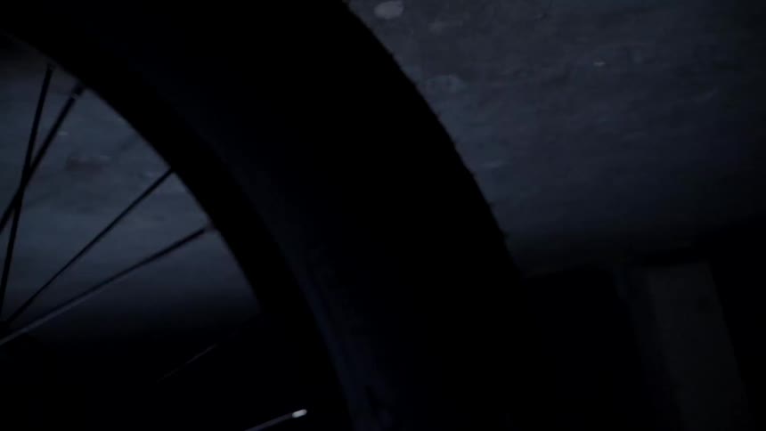 The tire is moving in the dark garage