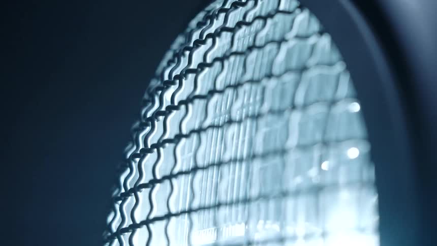 A small round window with an iron grille in front