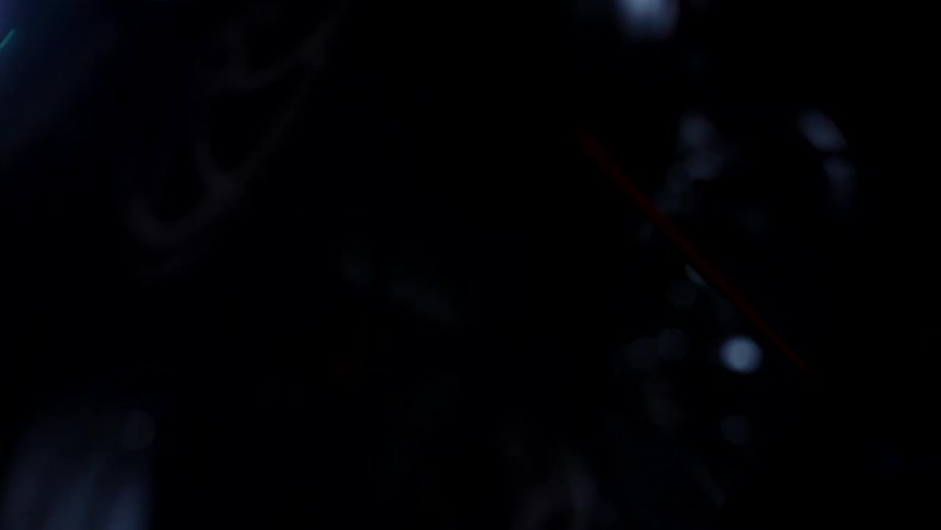 The gears and wheels of a bicycle are discernible in the darkness