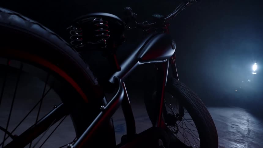 A bike is parked in the dark garage