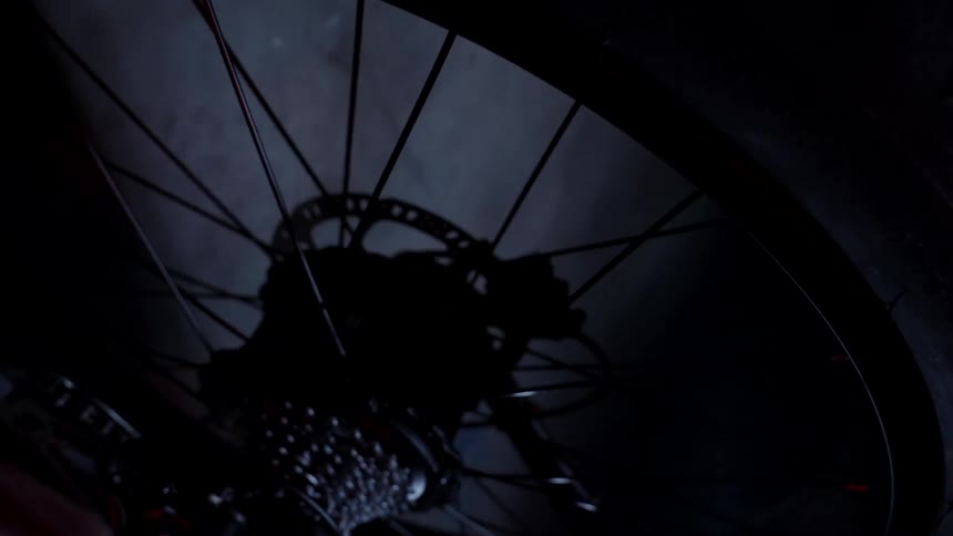 The camera spirals away from the rear wheel of a bicycle