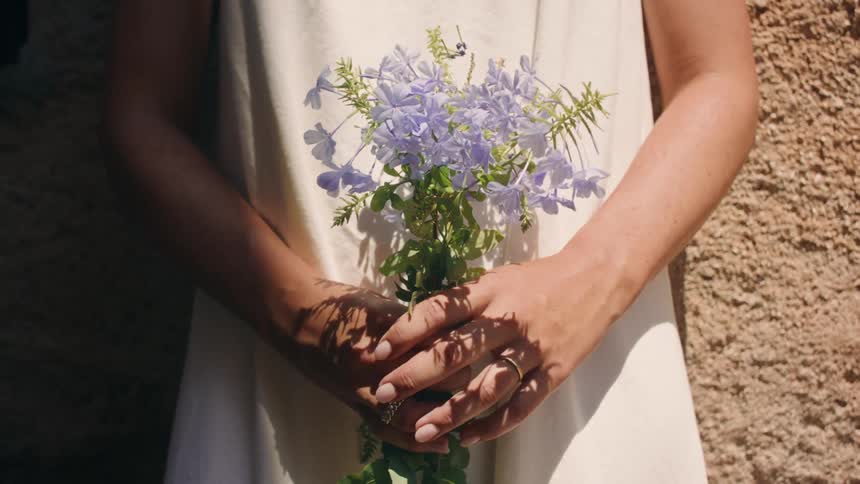 Closeup of hands holding flowers during the day