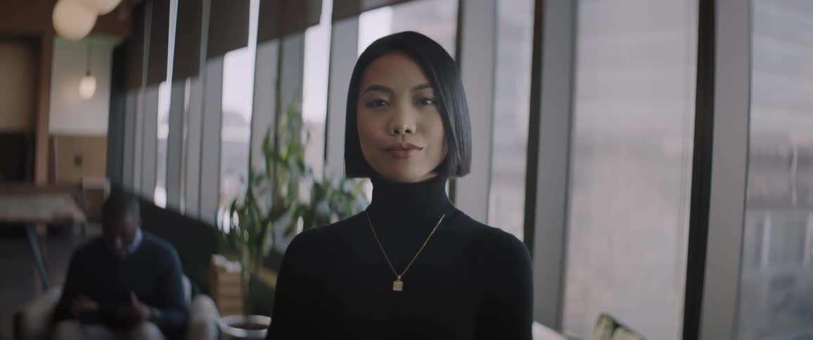A young woman poses for the camera with a look of confidence on her face