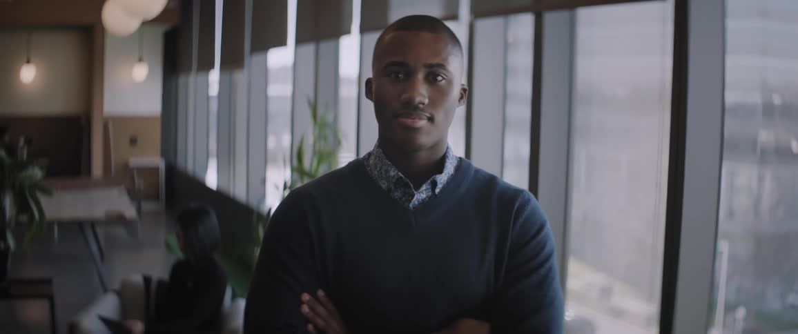 A man is standing with his arms folded