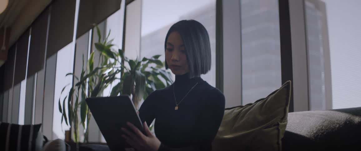 A woman is reading her tablet