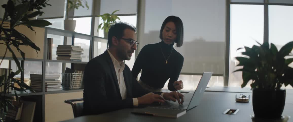 Coworkers talk while working at the office