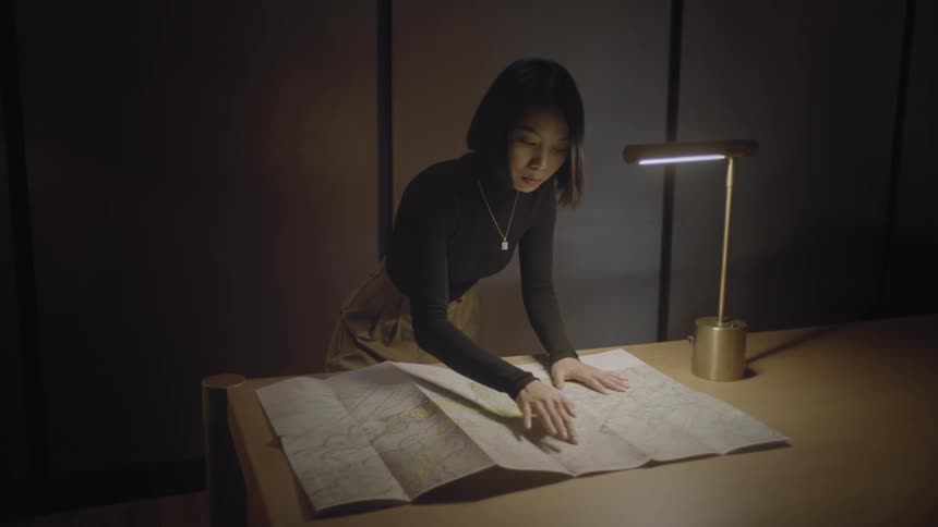 A young woman opened a map on her office desk