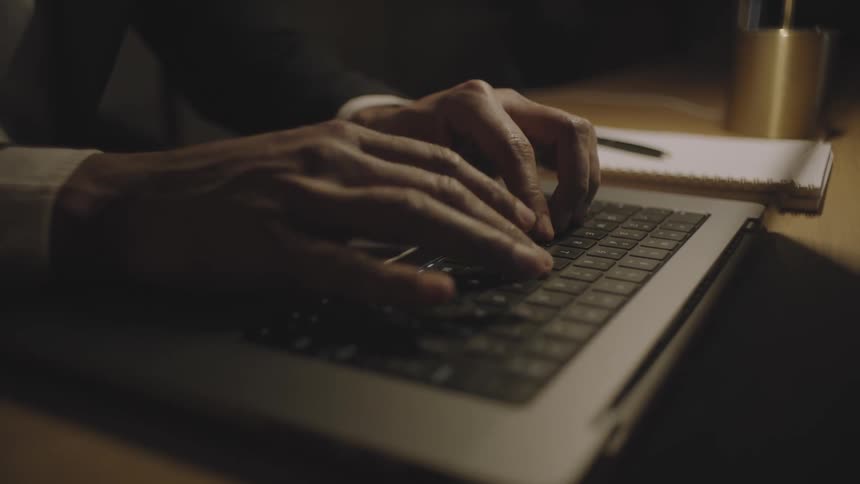 A person is typing on the laptop