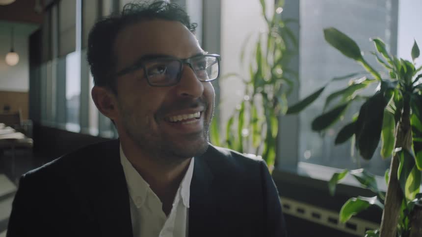 A man is laughing in the office