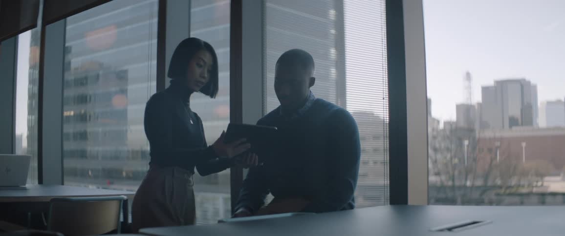 Two people are looking at a tablet together