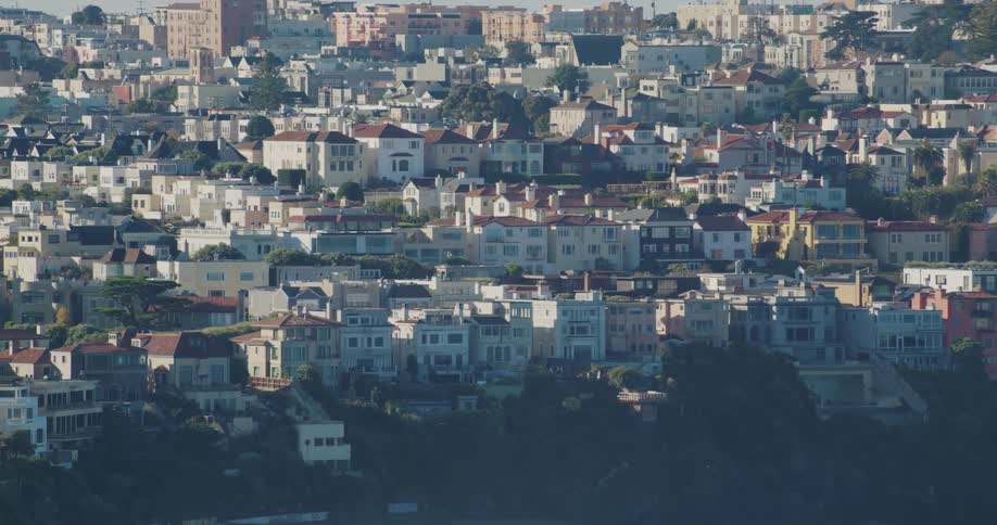 Town sits on mountainous slope on a foggy day
