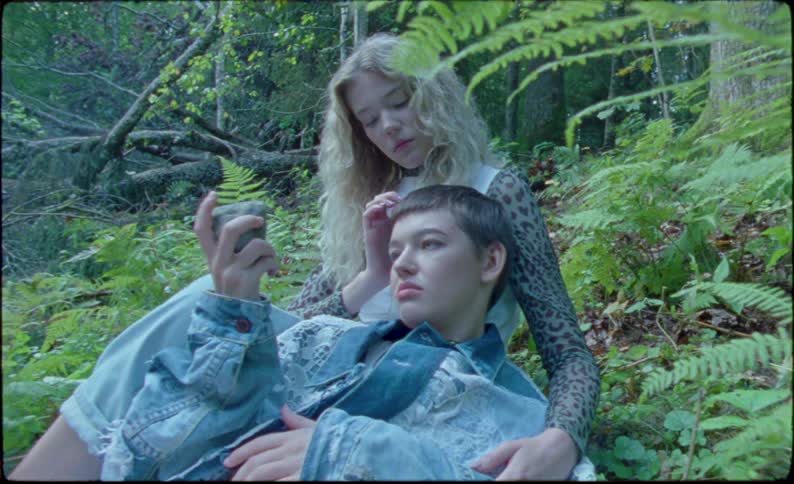 Young teenage couple relax in the forest
