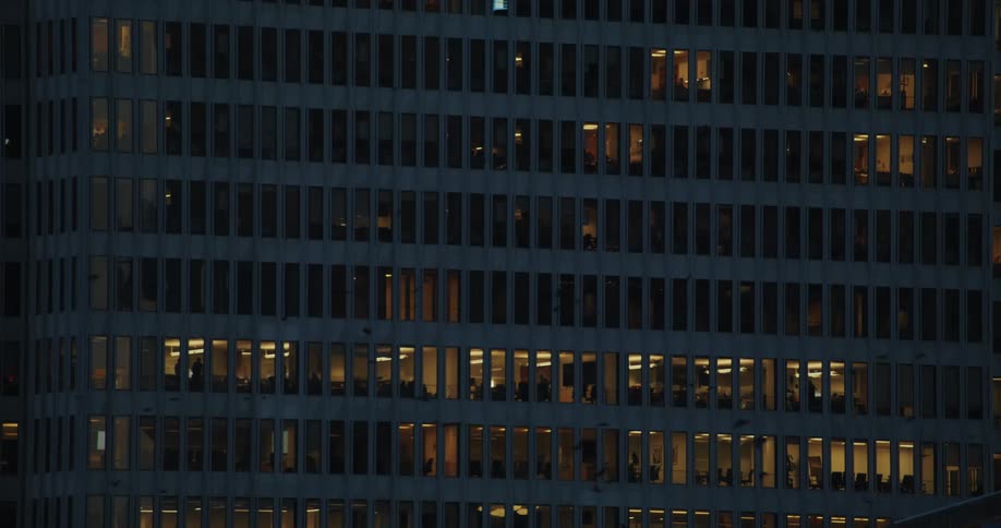 Birds flying over a building at dusk