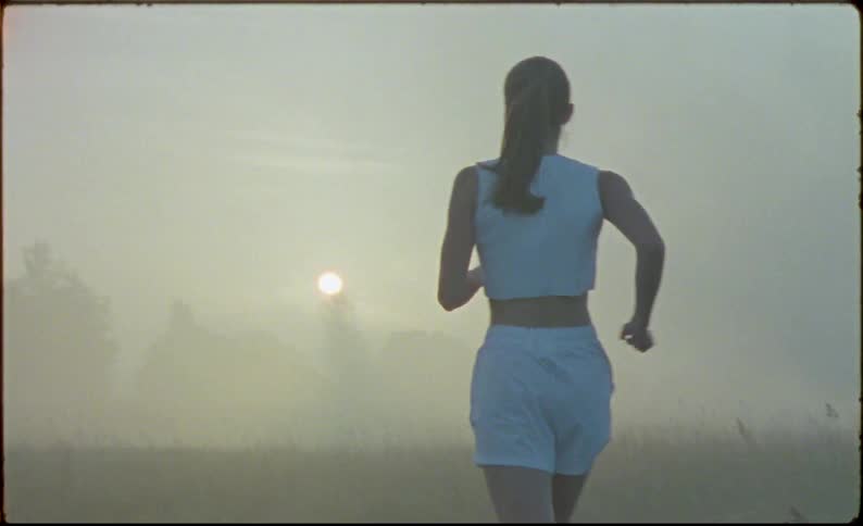 A woman is running in the fog