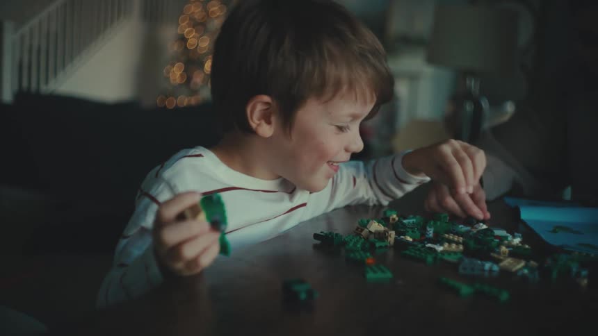 A boy is building with legos