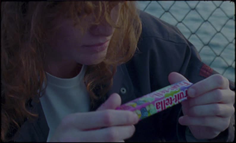 Awoman opens a package of sweets