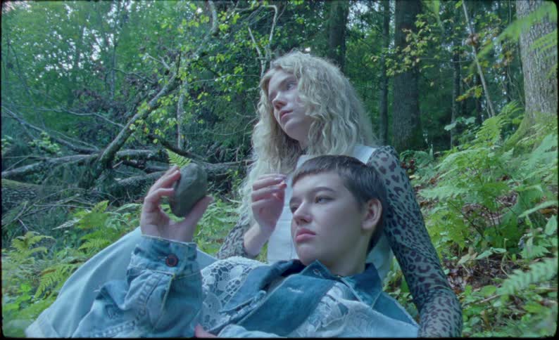 Young couple relax in the forest at daytime