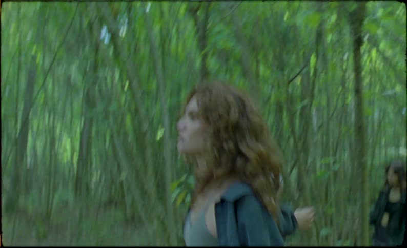 A girl and her friends walk through the forest during the day
